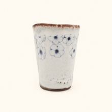 Spako Clay tumbler with blue floral patterns on a white background