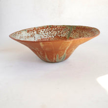 Ceramic bowl with textured surface on a white background