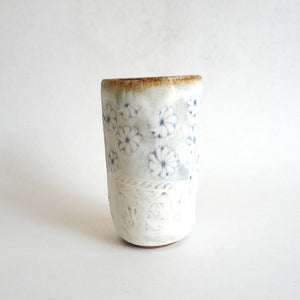 Spako Clay tumbler blue line drawing of flowers and emboss pattern, white glaze
