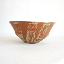 Ceramic bowl with decorative patterns on a white background