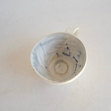 Cappuccino mug with blue flower pattern on beige background