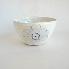Ceramic bowl with blue floral design on a white background
