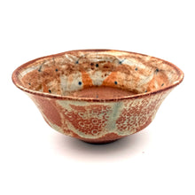 Ceramic bowl with speckled glaze on a white background