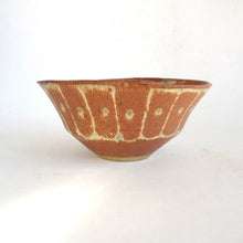 Ceramic bowl with a textured brown surface on a white background