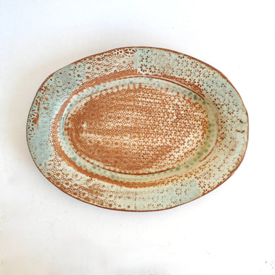 Ceramic plate with a textured design on a white background