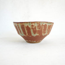 Ceramic bowl with a textured surface on a white background