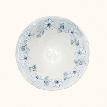 Ceramic bowl with blue floral pattern on a white background