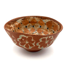 Ceramic bowl with floral patterns on a white background