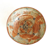 Ceramic bowl with a concentric design on a white background