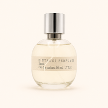 Perfume bottle with metal cap on white background