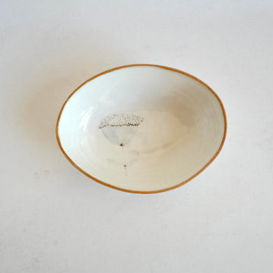 Small ceramic bowl with wild floral design on a white background