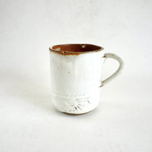 White ceramic mug with brown rim on a white background