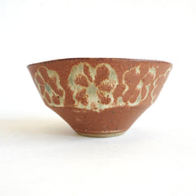 Ceramic bowl with decorative patterns on a white background