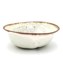 Ceramic bowl with a textured surface on a white background