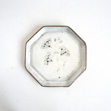 Octagonal ceramic plate with floral design on a white background