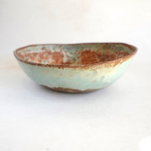 Ceramic bowl with a textured surface on a white background