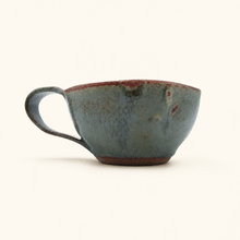 Ceramic cup with a textured surface on a white background