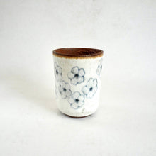 Ceramic cup with floral pattern on a white background