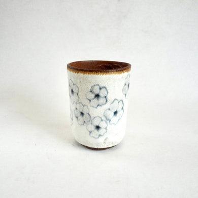 Ceramic cup with floral pattern on a white background