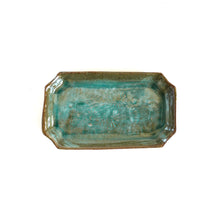 Rectangular ceramic tray with a textured greenish-brown surface on a white background