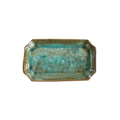 Rectangular ceramic tray with a textured greenish-brown surface on a white background