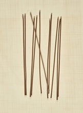 Thin sticks on a beige textured background