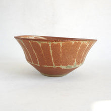 Ceramic bowl with a textured brown surface on a white background