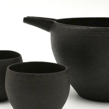 Set of black ceramic bowls on a white background