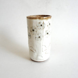 Spako Clay tumbler black line drawing of flowers and emboss pattern, white glaze
