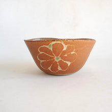 Ceramic bowl with floral design on a white background
