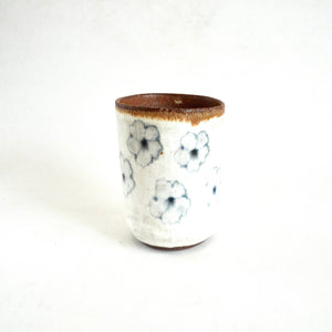 Ceramic cup with floral patterns on a white background
