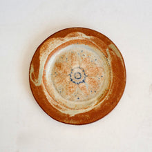 Ceramic plate with a textured design on a white background