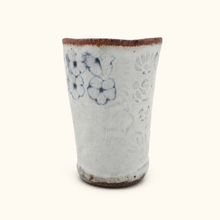 Spako Clay tumbler with blue floral patterns on a white background