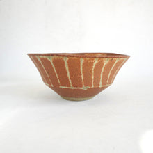 Ceramic bowl with striped pattern on a white background
