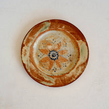 Ceramic plate with floral design on a white background