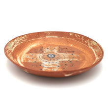 Ceramic plate with decorative patterns on a white background