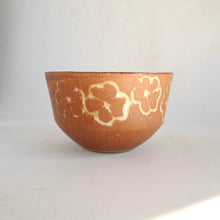 Ceramic bowl with a textured surface on a light gray background