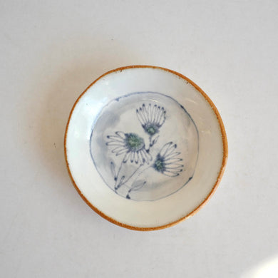 small plate with  blue daisies pattern on white background