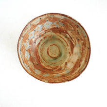 Ceramic bowl with a textured surface on a white background