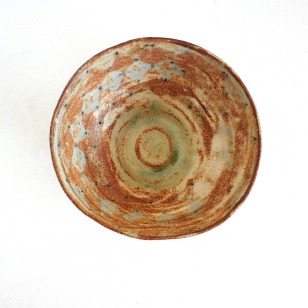 Ceramic bowl with a textured surface on a white background