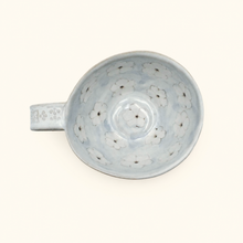Ceramic mug with floral pattern on a white background
