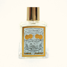 L. T. Piver Perfume bottle with gold cap and decorative label on a white background