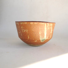 Ceramic bowl with a textured surface on a white background