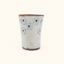 Spako Clay tumbler with blue floral patterns on a white background