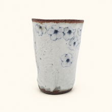 Spako Clay tumbler with blue floral patterns on a white background
