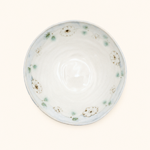 Ceramic bowl with floral patterns on a white background