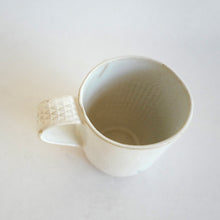 Mug with pattern on handle on beige background