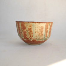 Ceramic bowl with striped pattern on a white background