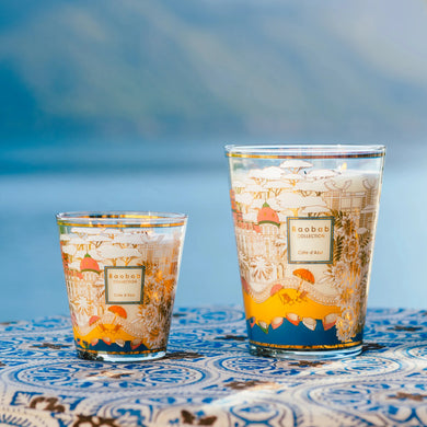 Two decorative glasses with a scenic background