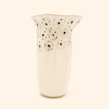 White ceramic vase with flower pattern on a white background